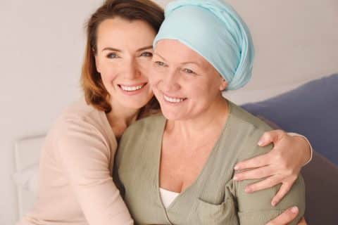 Young woman visiting her mother with cancer indoors